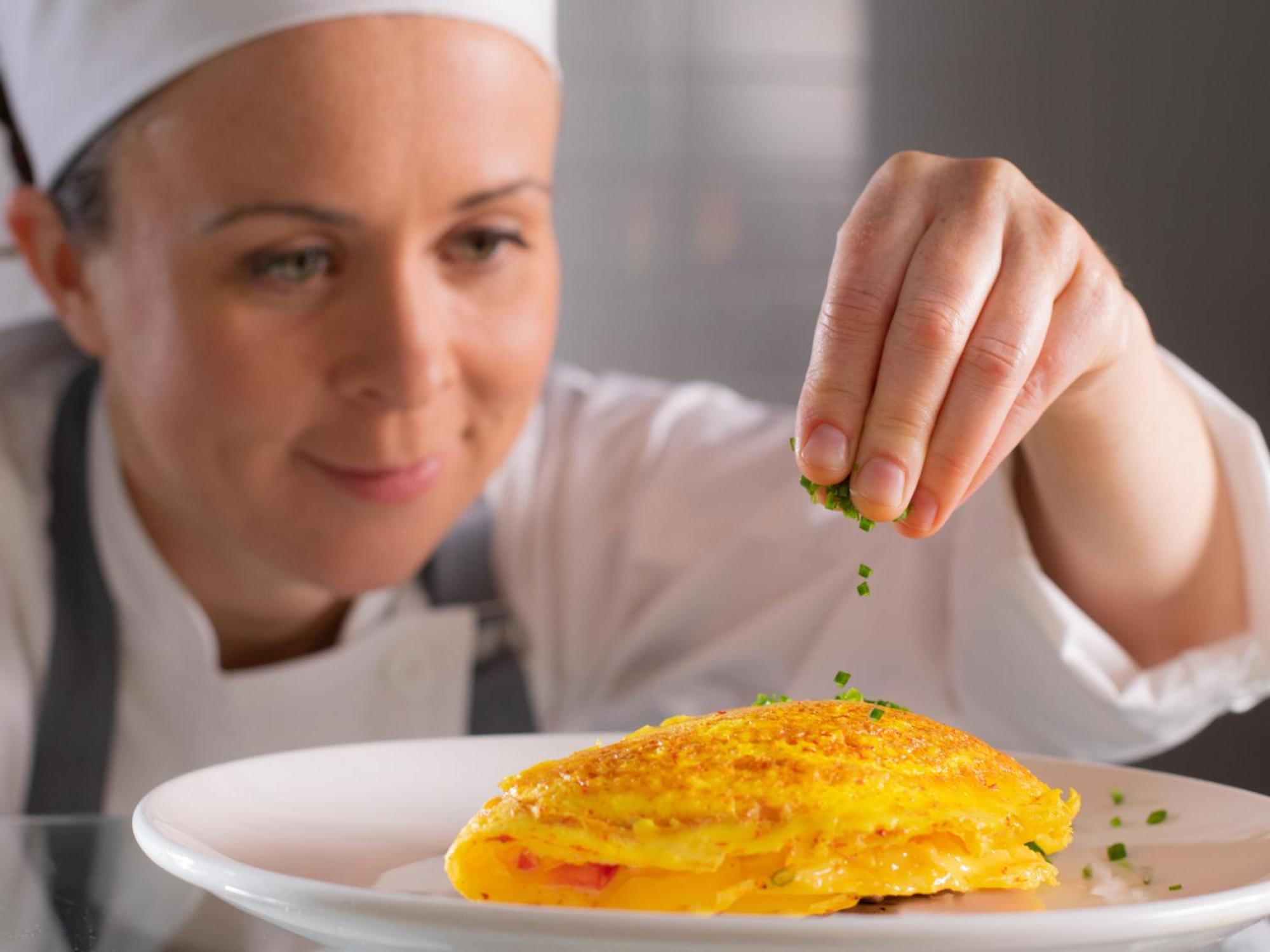 Otl Gouverneur Sherbrooke Exterior foto A chef seasoning a dish